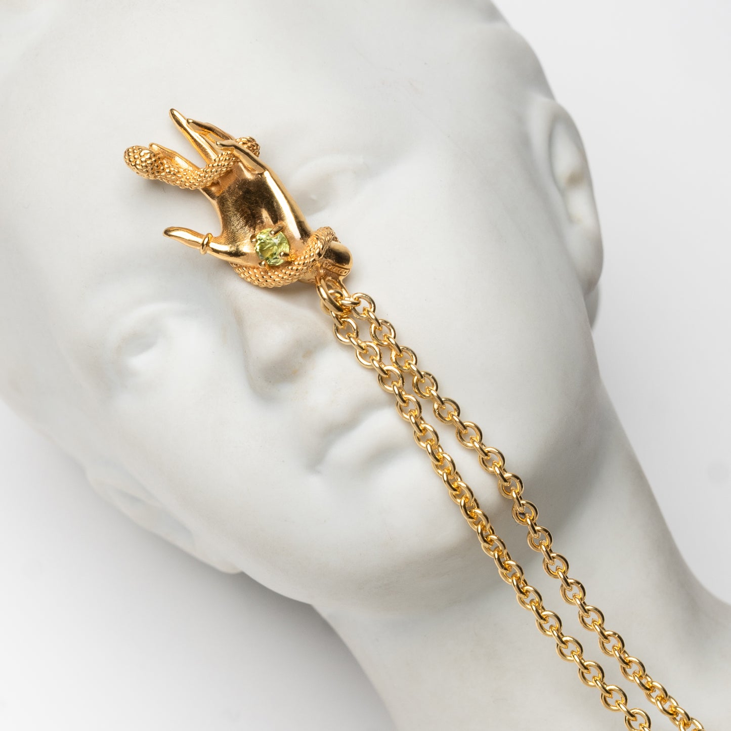DESIDERIO - pendente mano con serpente in oro giallo e pietra peridot verde